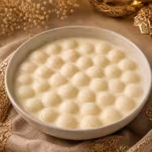 Sponge rasmalai absorbing saffron rabri - Manha Sweets